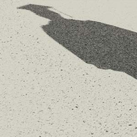 shadow with a motorboard on concrete