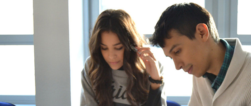 A man and a woman looking down as they work.