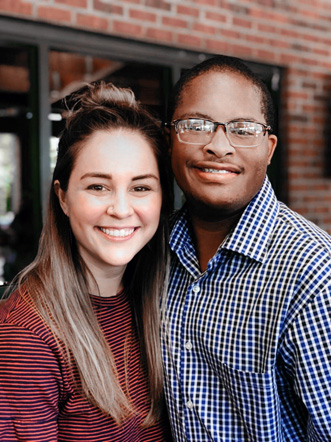 Two smiling people, one white and one African American