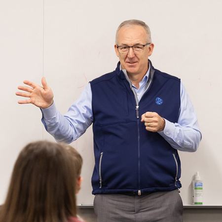 SEC Commissioner Greg Sankey speaks to a class