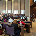 Wide shot of the AI symposium crowd