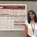 Student standing in front of research board