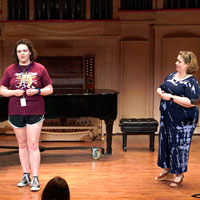 Student sings during voice lesson.