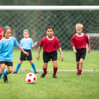 Kids playing soccer.
