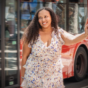 Morgan Epperson smiles while leaning on a payphone booth in London, England.